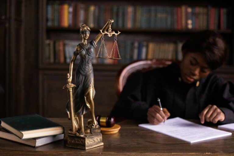 Why Top Nigerian Law Firms are Restructuring their Websites to Survive the 'AI Search' Revolution. 2 Why Top Nigerian Law Firms are Restructuring for AI Search: A focused judge writing on documents beside a Lady Justice statue in an office.