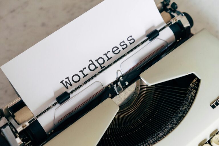 Avoid a Costly Mistake: 5 Critical Questions to Ask Before You Hire a WordPress Developer 5 Close-up of a vintage typewriter with a paper displaying 'WordPress', ideal for blogging and writing concepts.
